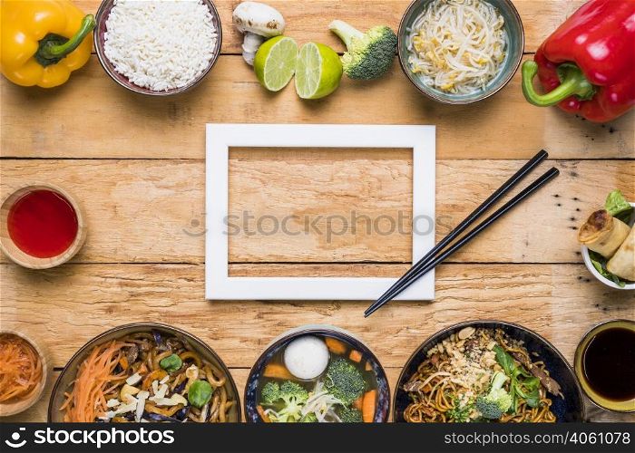 white border frame with chopsticks thai traditional food wooden desk