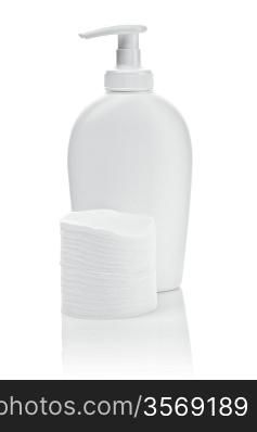 white bottle and cotton pads