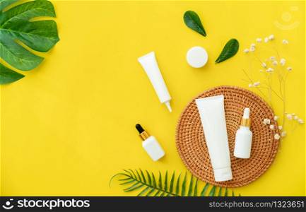 White bottle cream, mockup of beauty product brand. Top view on the yellow background.