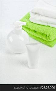 white bottle tube and towels