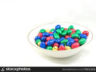white bowl of easter eggs isolated on white background
