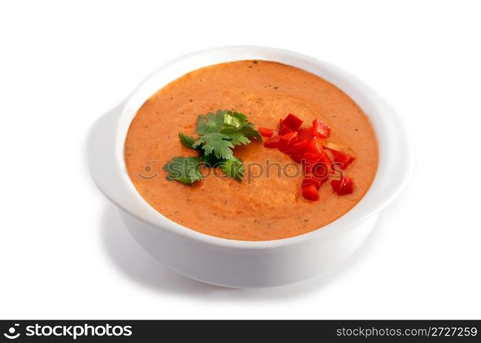 White bowl of gaspacho soup on white background