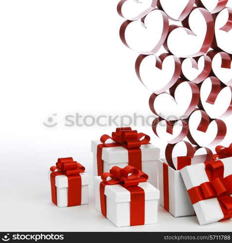 White boxes with red ribbons and decorative hearts isolated on white background