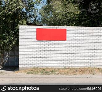 White brick wall background with red banner