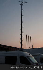 White broadcast trucks recording and broadcasting a live event