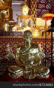White Buddha and silver monk inside temple in wat Suan Dok, Chiang Mai, Thailand