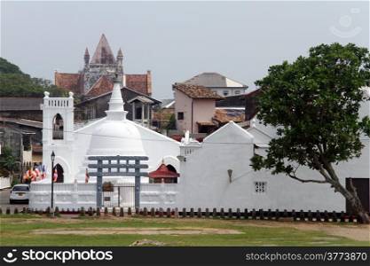 White buddhist dagoba and dutch church in Galle, Sri Lanka