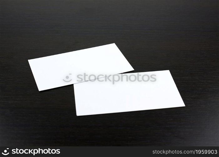 White business cards on wooden surface ideal for mockup