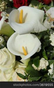 White calla lillies in a white flower arrangement, wedding decorations