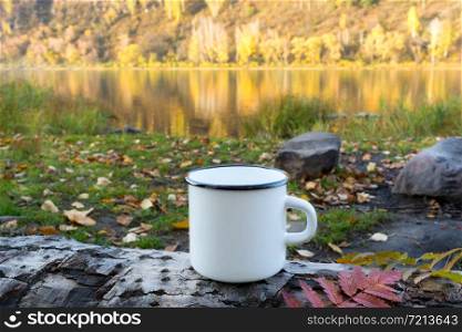 White campfire enamel coffee mug mockup with red viburnum leaf. Empty mug mock up for design promotion.