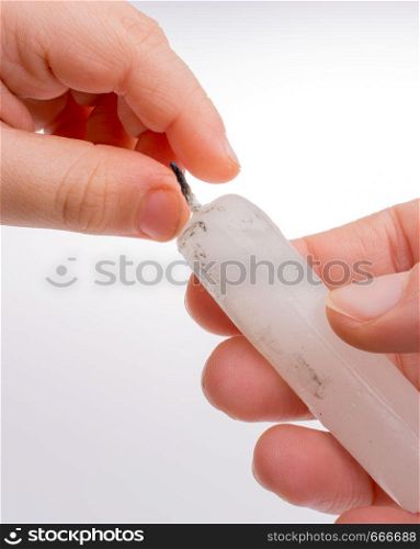 White candle stick in hand on a white background