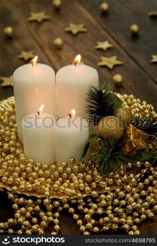 White candles on a rustic wooden background