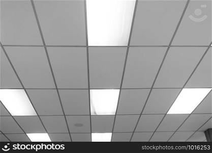 White ceiling with neon light bulbs in uprisen view.as background interior decoration concept with copy space for your text or design.