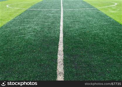 White center line of soccer field. Center line on artificial grass football field