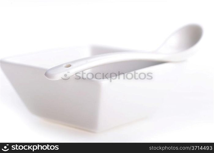 White ceramic bowl and spoon on table