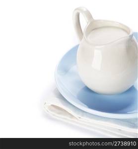 white ceramic jug with milk on a blue plate