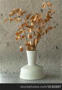 White ceramic vase and dried flower
