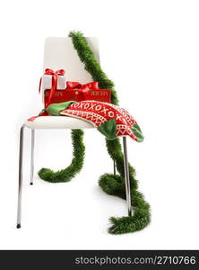 White chair with gifts and garland on white