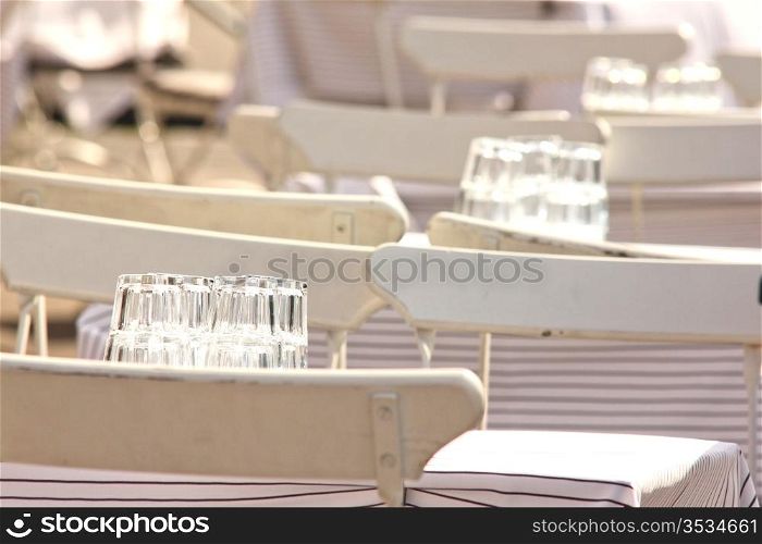 White chairs and tables, outdoors at a restaurant