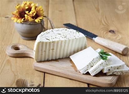 White cheese and spices on a wooden board on a white background.. White cheese and spices on a wooden board on a white background