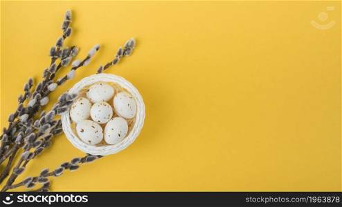 white chicken eggs bowl with willow branches. High resolution photo. white chicken eggs bowl with willow branches. High quality photo