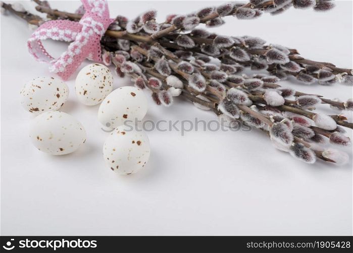 white chicken eggs with willow branches. Beautiful photo. white chicken eggs with willow branches