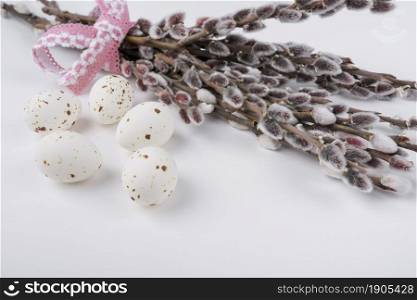 white chicken eggs with willow branches. Beautiful photo. white chicken eggs with willow branches