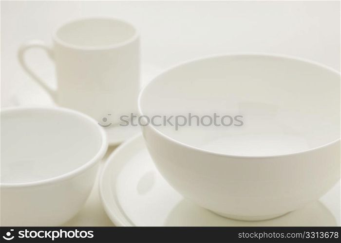 white china bowls and coffee cup, selective focus abstract