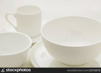 white china bowls and coffee cup, selective focus abstract