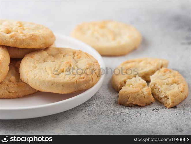 White chocolate biscuit cookies on white ceramic plate on light table background.