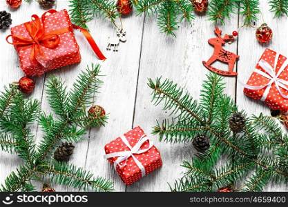 White Christmas background with ornaments,gifts and fir branches