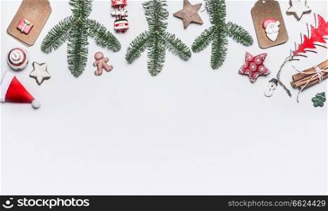 White Christmas background with various decoration, fir branches and cookies , top view with copy space for your design