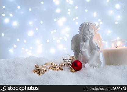 White christmas - cute angel in snow , blue night with lights in background. Happy Christas and holidays concept.. White christmas with snow