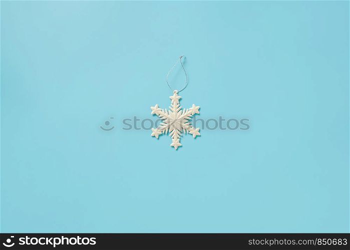 White christmas decoration snowflake toy on blue background with copy space. Concept Merry christmas or Happy new year. Minimal style Top view Flat lay Template for your design, card, invitation.. White christmas decoration snowflake toy on blue background with copy space. Concept Merry christmas or Happy new year. Minimal style Top view Flat lay Template for your design, card, invitation