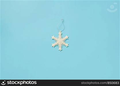 White christmas decoration snowflake toy on blue background with copy space. Concept Merry christmas or Happy new year. Minimal style Top view Flat lay Template for your design, card, invitation.. White christmas decoration snowflake toy on blue background with copy space. Concept Merry christmas or Happy new year. Minimal style Top view Flat lay Template for your design, card, invitation