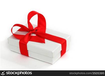 white christmas gift with red heart ribbon
