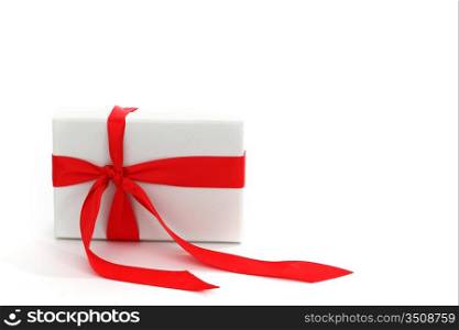 white christmas gift with red ribbon