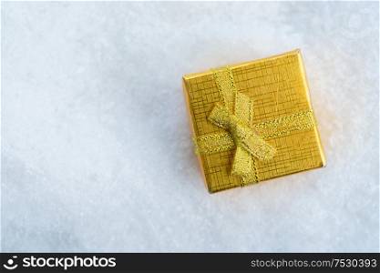 White christmas. - golden gift box in snow. White christmas with snow