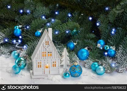 White christmas house. White christmas house with blue decorations and evergreen tree in snow