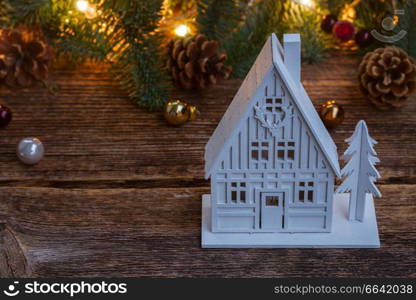 White christmas house with fir tree and defocused lights. White christmas house