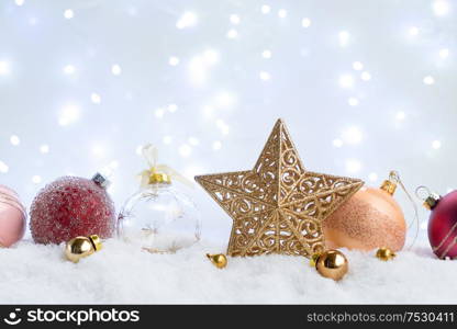 White christmas with snow - decorative balls and star close up with lights in background. White christmas with snow