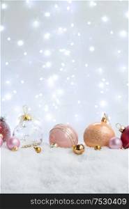 White christmas with snow - pink and golden decorations close up. Happy Christas and holidays concept.. White christmas with snow