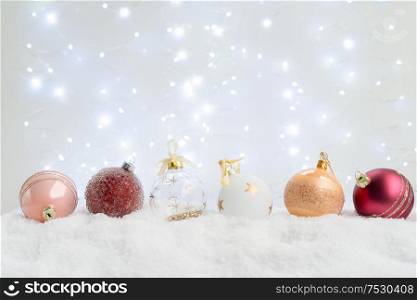 White christmas with snow - pink and golden decorations close up. White christmas with snow