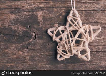 White christmas wooven star over wooden background