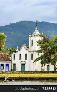White church near the sea on the south coast of the state of Rio de Janeiro founded in the 17th century. White church near the sea in the ancient and historic city of Paraty