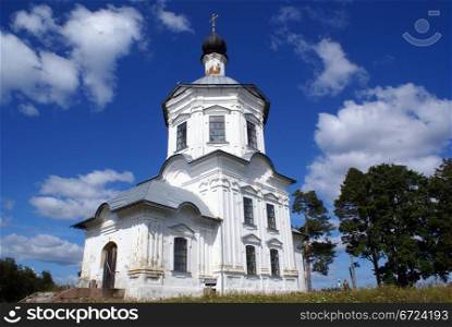White church with golden cross in Nilova Pustyn, Seliger, Russia