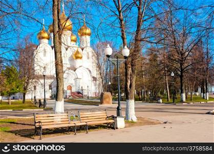 White church with golden domes in the park