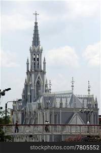 White church with spire in Kali, Colombia