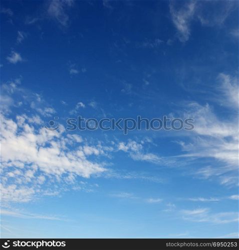 White cirrus clouds against the blue sky. Heavenly background.