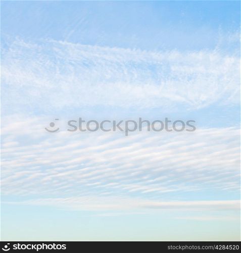white cirrus clouds in blue afternoon sky in October